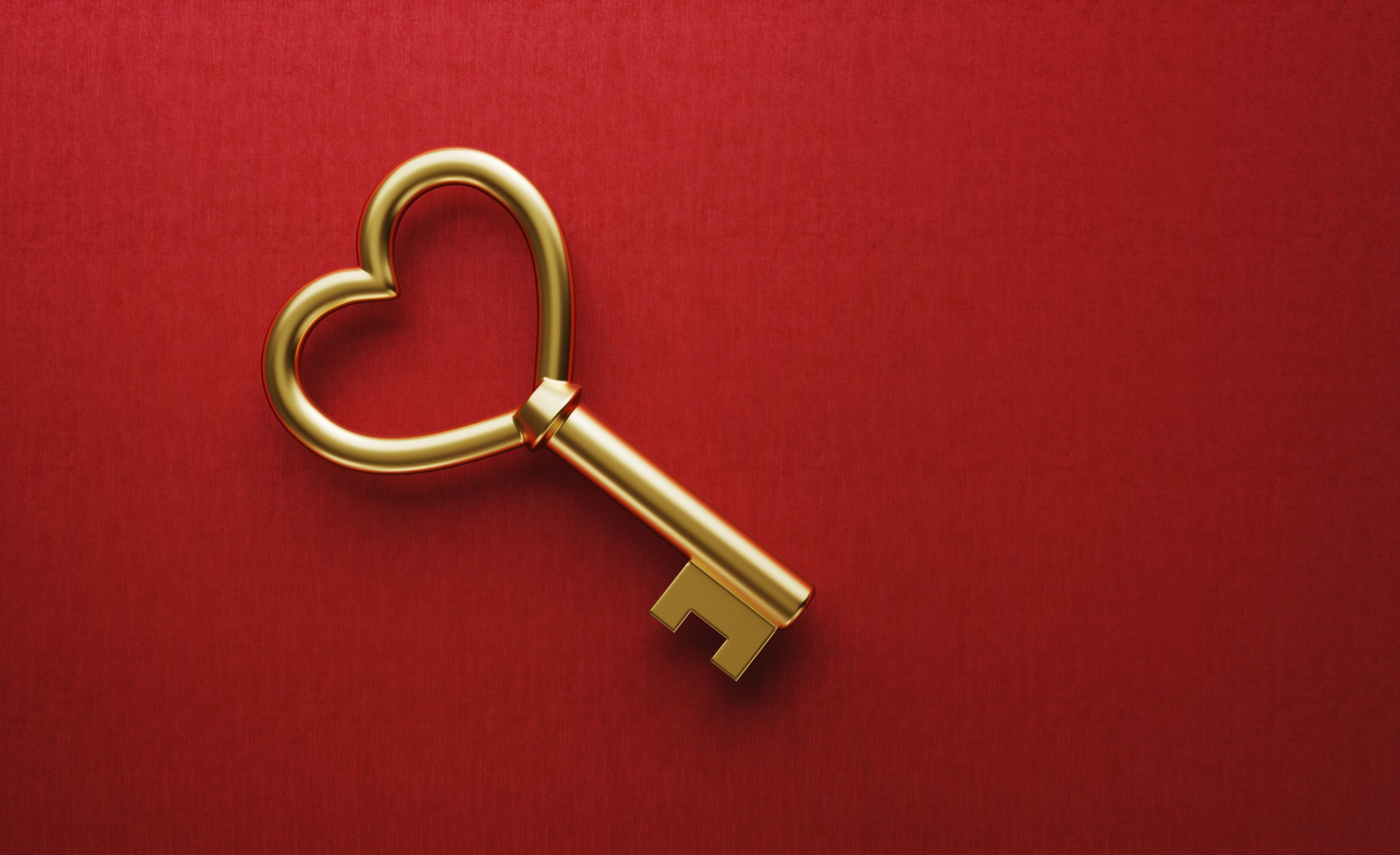 Gold Heart Shaped Key on Red Background